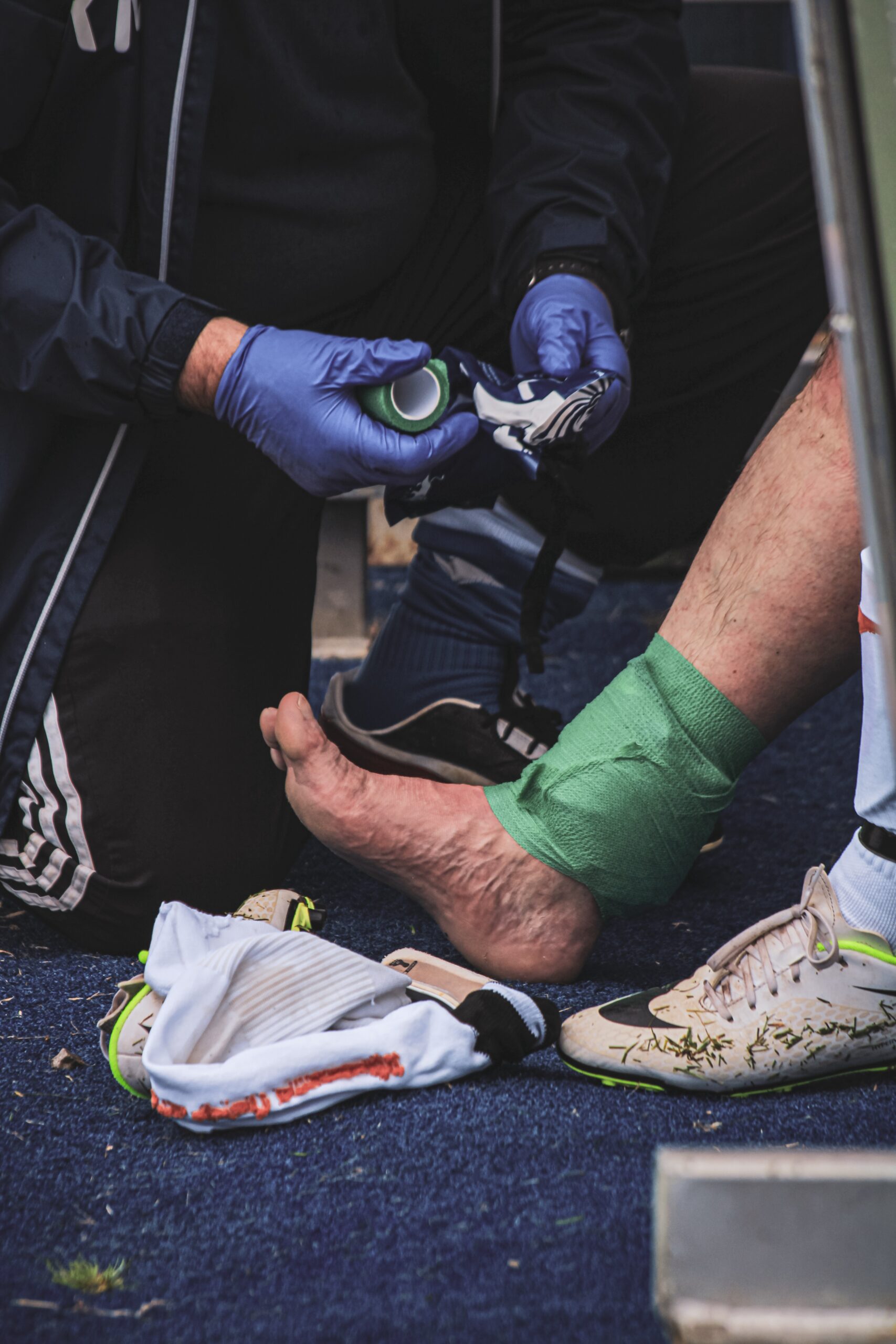 Man helping a player with an injury during the game
