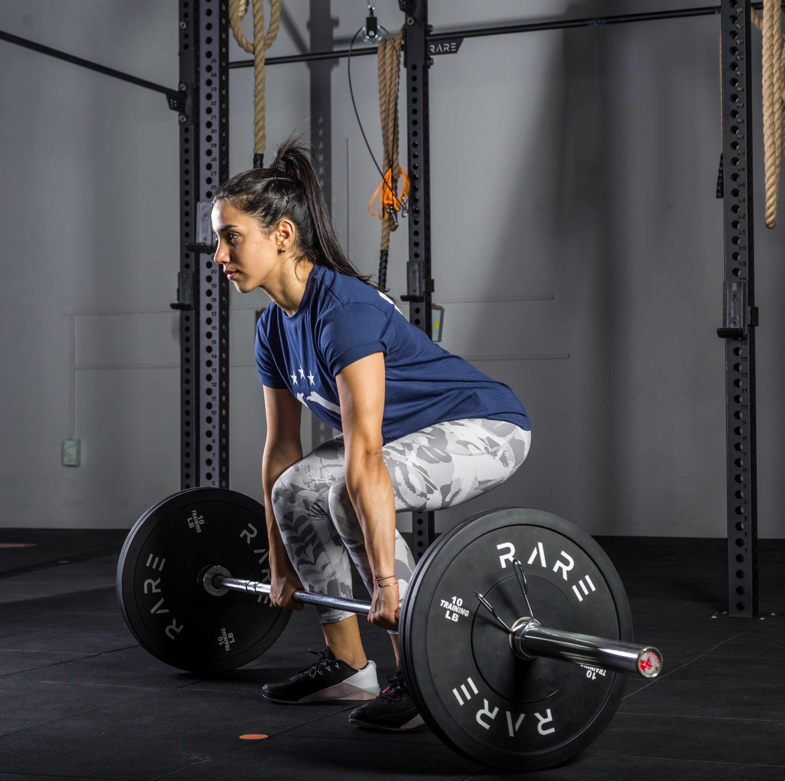 a young woman in sportswear wear lifting a barbell