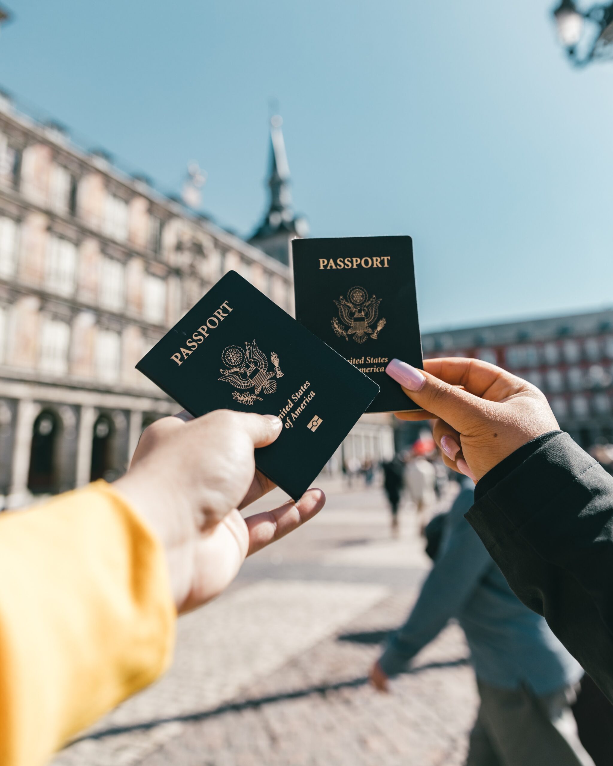 anonymous tourist showing us passports on street sunny day