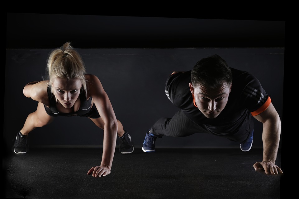 man and woman doing push up exercise