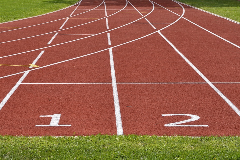 maroon track field, curved and straight-line markers, number 1 and 2 marker