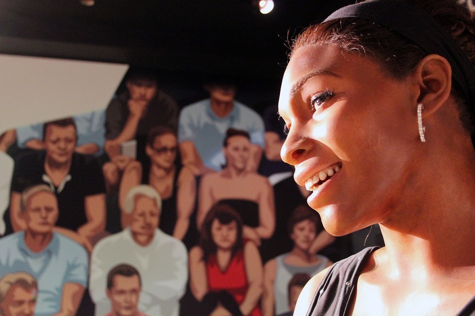 wax mannequin of Serena Williams, a crowd of spectators as a background
