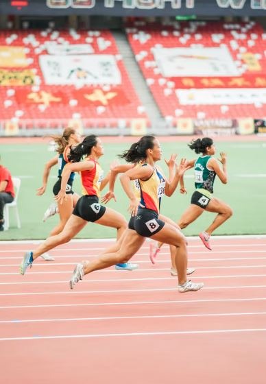 women athlete running on a racetrack
