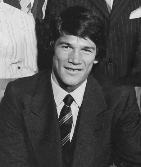 a black and white photo of Carlos Monzon wearing a suit