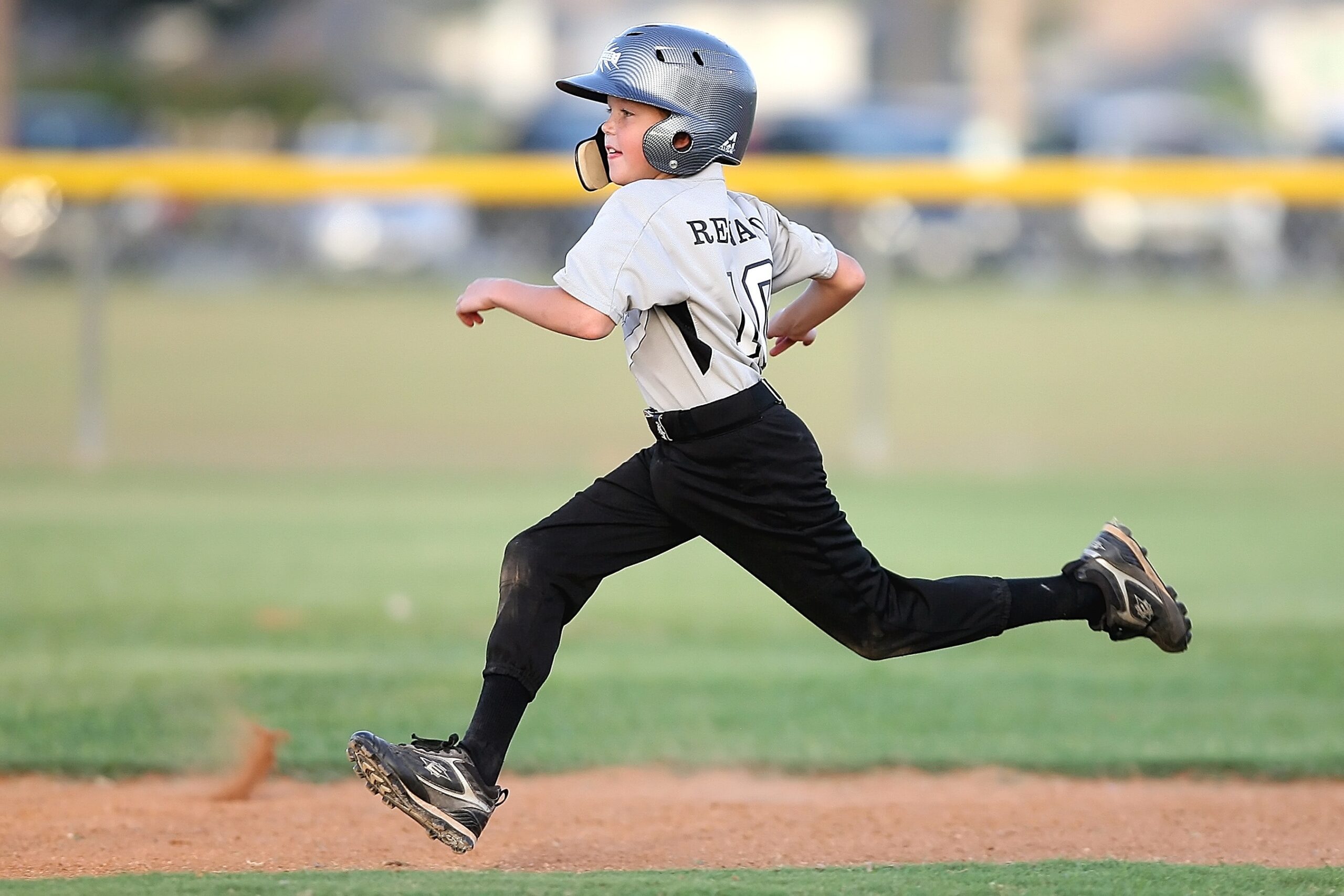 baseball-player-in-gray-and-black-uniform-running