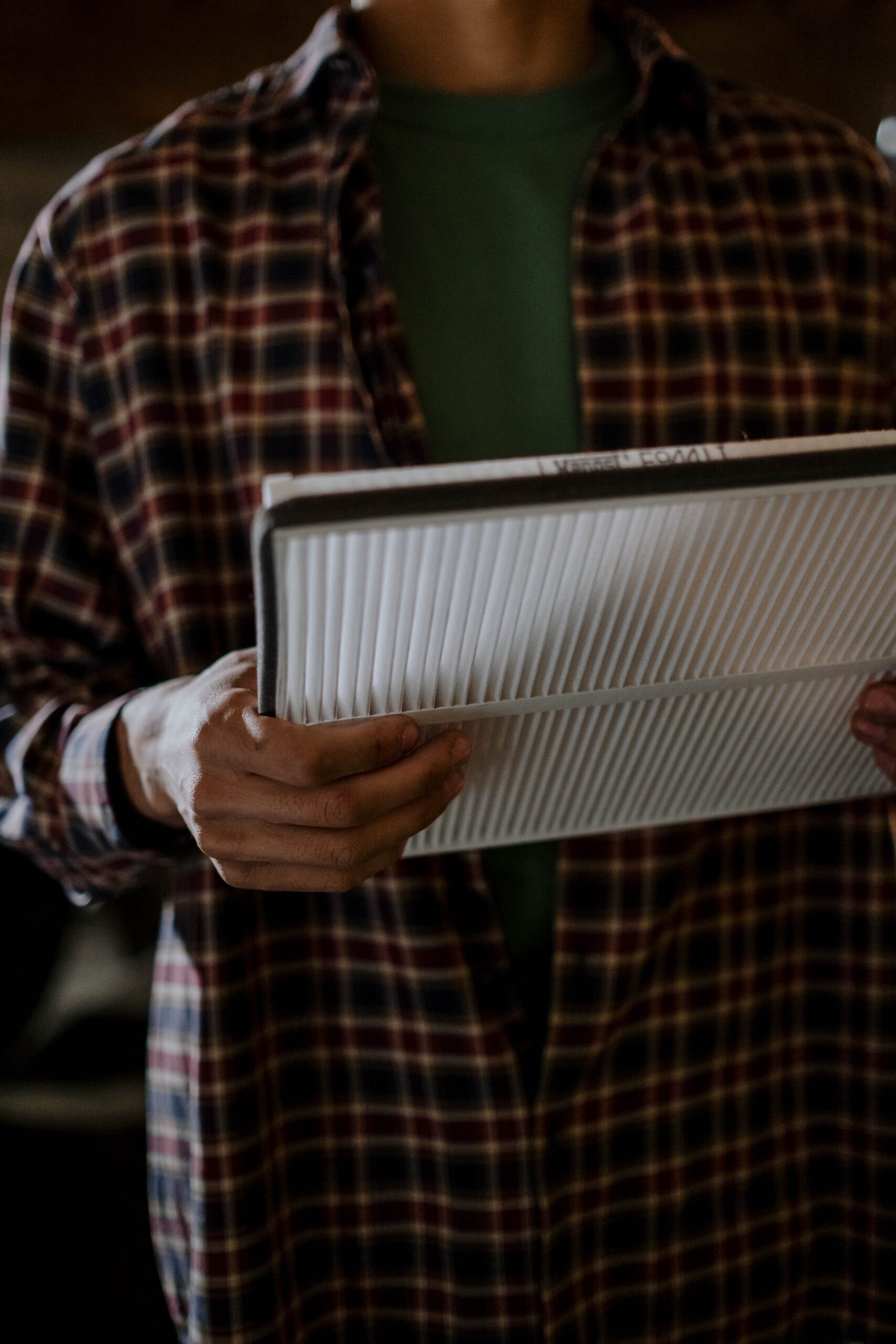 A person holding a new cabin filter